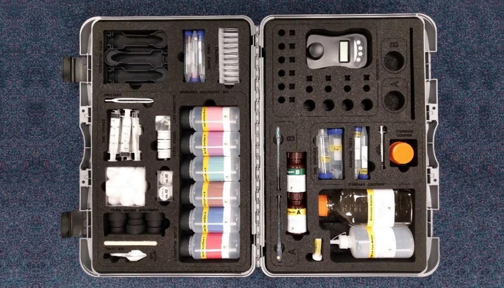 An open case containing components of a rapid soil phosphate kit
